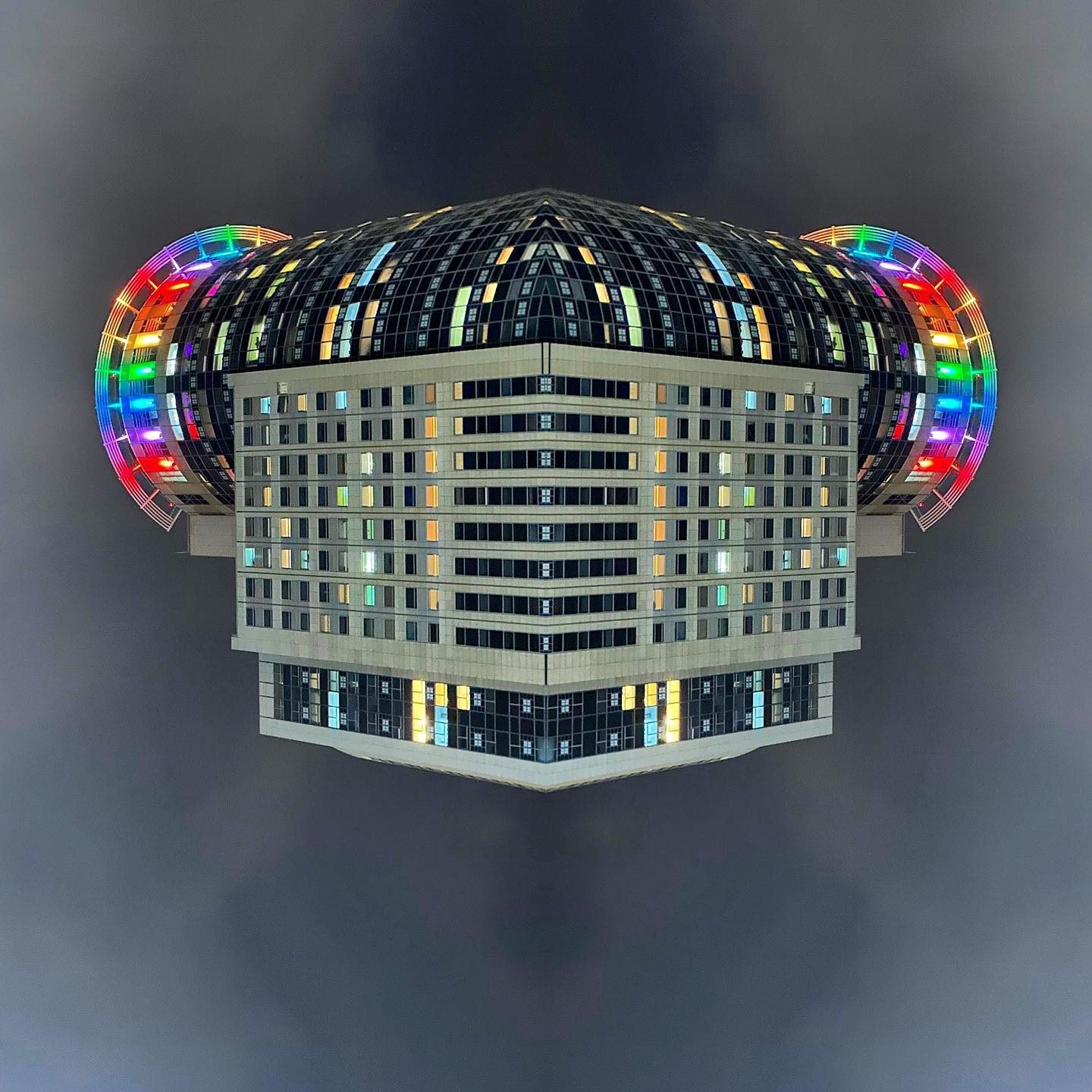 Futuristic architectural structure with rainbow rings and dome