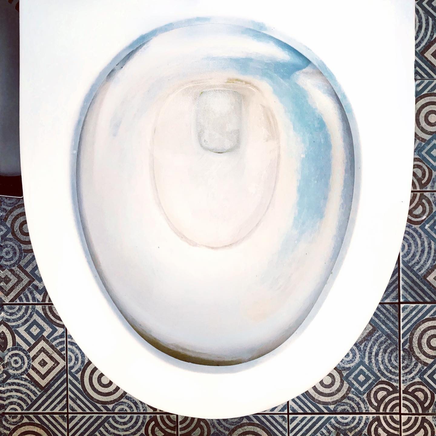 Toilet bowl with blue stain
